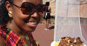 A beautiful young lady with her plate of food from A Taste of Africa